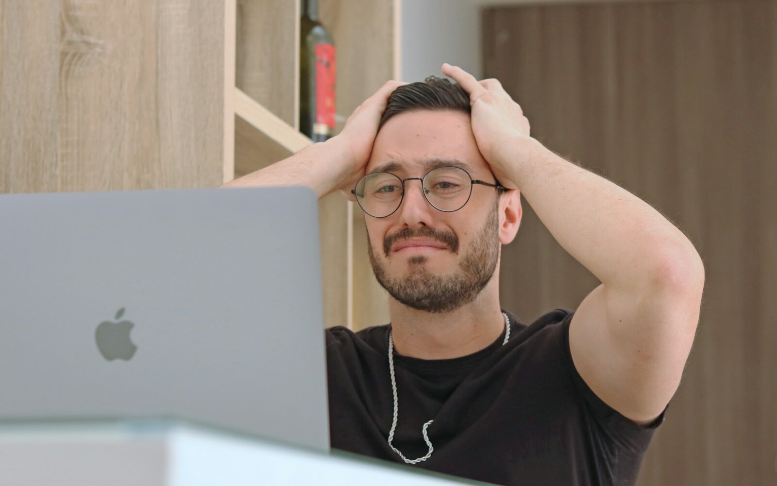 Frustrated SEO specialist at a desk with rankings dropped